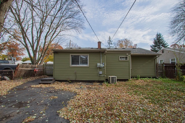 rear view of property with central AC, a patio area, and fence private yard