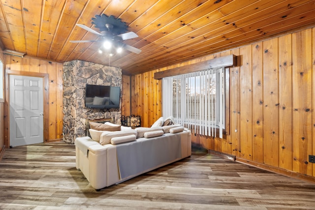 living area with wood walls, wood ceiling, a ceiling fan, and wood finished floors