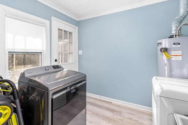 laundry room with electric water heater, light wood-style floors, baseboards, laundry area, and washing machine and clothes dryer