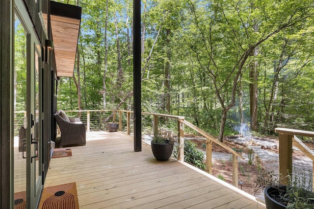 wooden deck featuring a wooded view