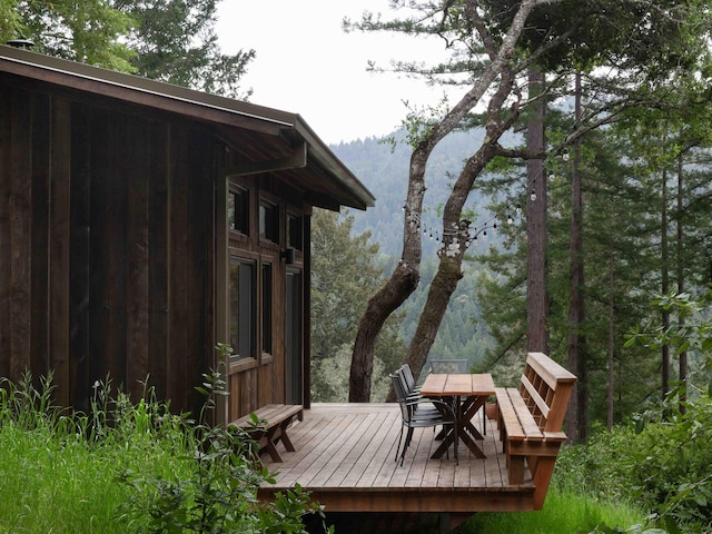 wooden terrace with outdoor dining space