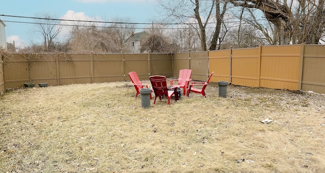 view of yard featuring an outdoor fire pit and a fenced backyard