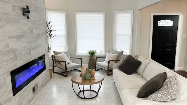 living room featuring a tiled fireplace