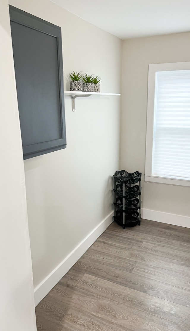 spare room featuring wood finished floors and baseboards