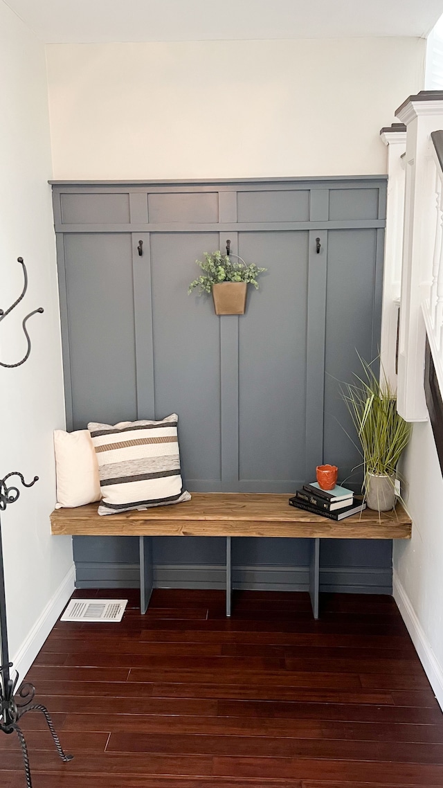 mudroom featuring baseboards and wood finished floors