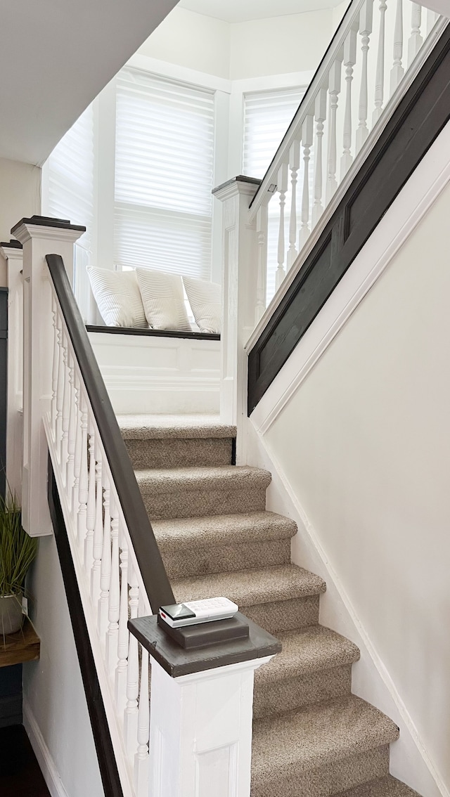 staircase featuring baseboards