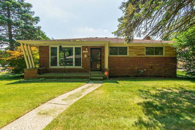 view of front of home featuring brick siding, a porch, and a front yard