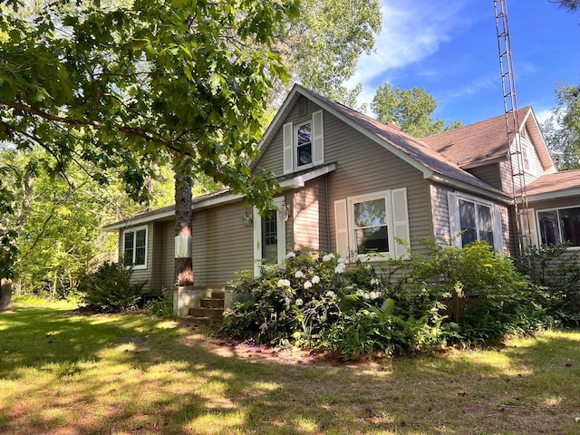 view of side of home with a lawn