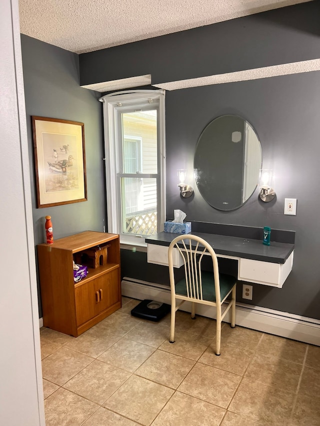 bathroom with tile patterned flooring, a textured ceiling, baseboards, and a baseboard radiator