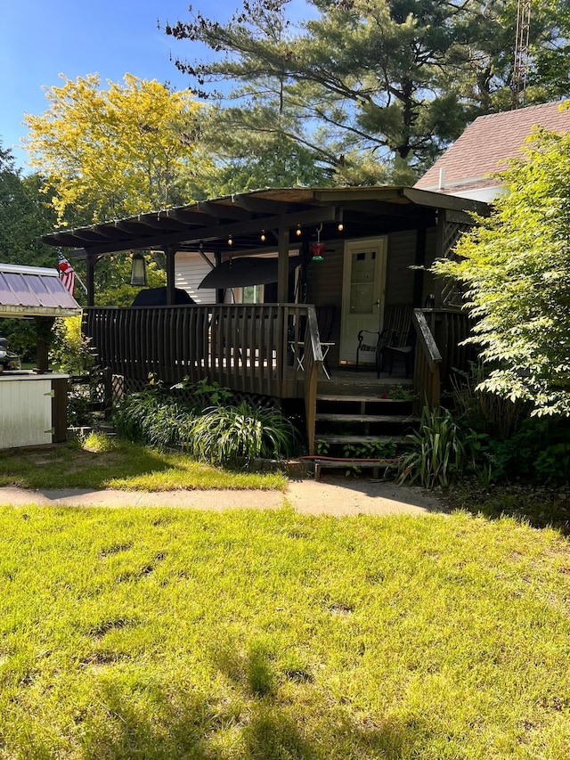 view of front of house with a wooden deck and a front lawn