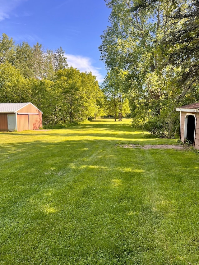 view of yard featuring an outbuilding and a pole building