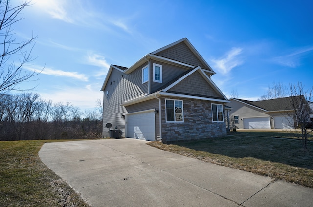 view of front facade with cooling unit, an attached garage, a front lawn, concrete driveway, and stone siding