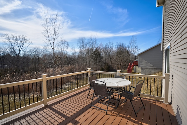 wooden terrace with outdoor dining space