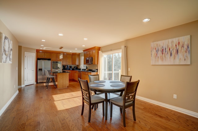 dining area featuring recessed lighting, baseboards, and light wood-style floors