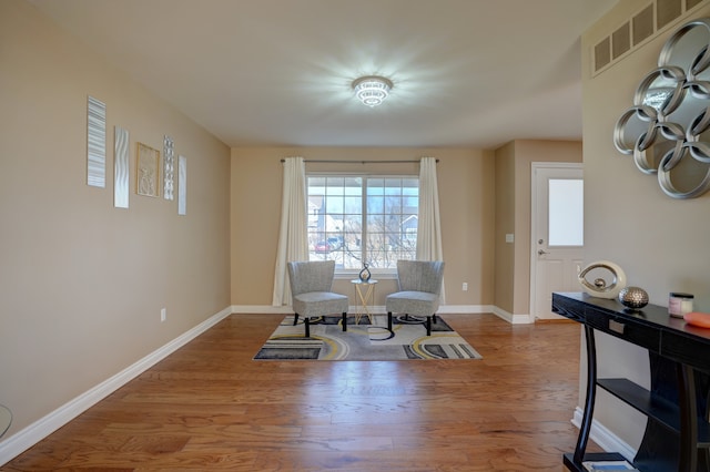 sitting room featuring baseboards and wood finished floors