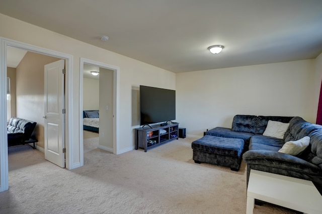 carpeted living room with baseboards