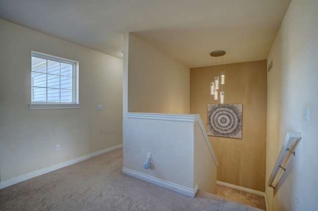 staircase featuring visible vents, baseboards, and carpet floors