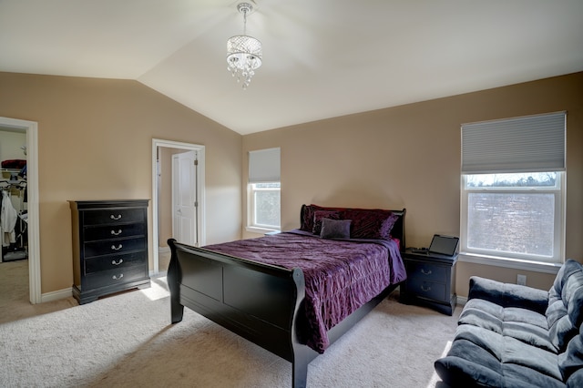 carpeted bedroom featuring vaulted ceiling, multiple windows, baseboards, and a chandelier