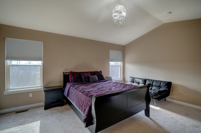 bedroom featuring visible vents, baseboards, lofted ceiling, light carpet, and a notable chandelier