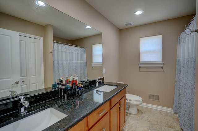 full bathroom with a sink, visible vents, and toilet