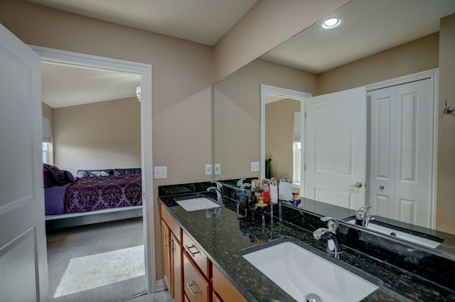 full bathroom with a sink, ensuite bath, and double vanity