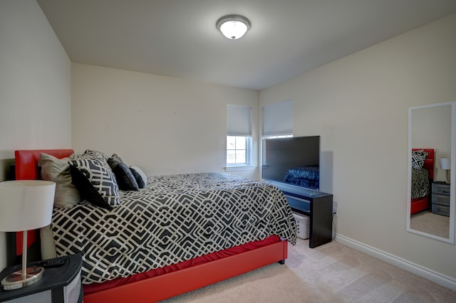 bedroom featuring baseboards and carpet floors