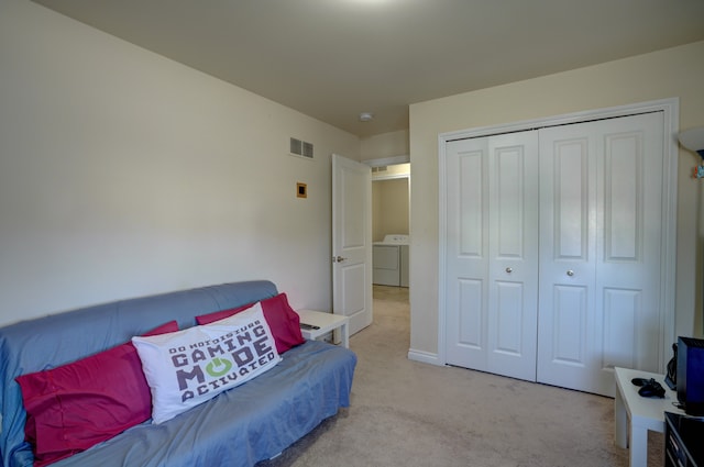 interior space featuring visible vents, carpet floors, and washer and clothes dryer