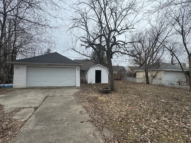 detached garage featuring fence