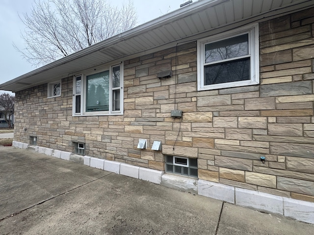 view of side of home featuring stone siding