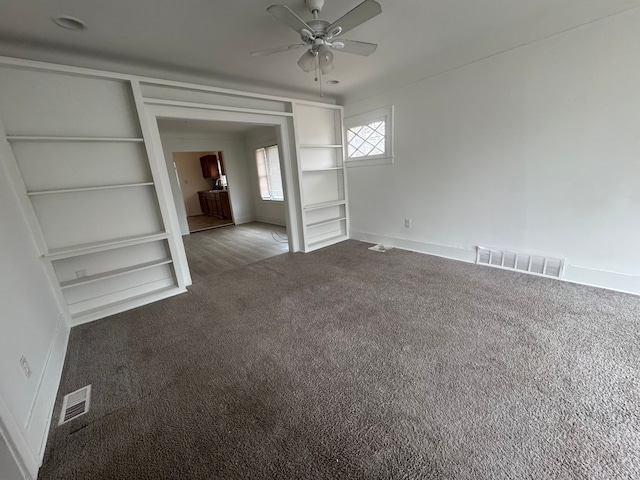 interior space featuring carpet floors, baseboards, and visible vents