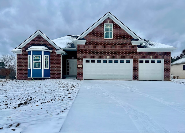 traditional-style house with a garage, driveway, and brick siding