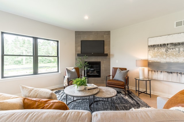 living room with a fireplace, recessed lighting, visible vents, wood finished floors, and baseboards