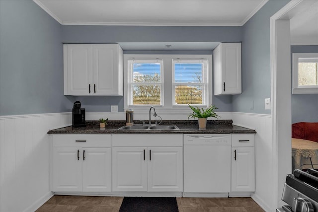 kitchen with a sink, white cabinetry, wainscoting, stove, and dishwasher