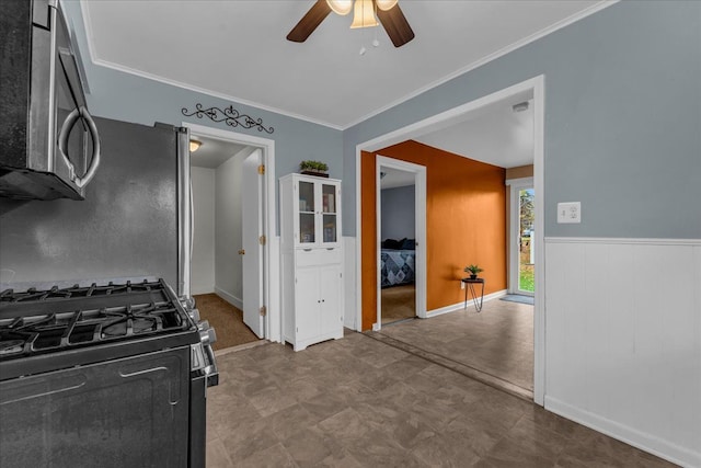 kitchen featuring ceiling fan, stainless steel microwave, black range with gas cooktop, and ornamental molding