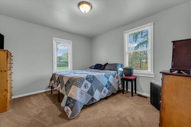 bedroom featuring baseboards and light carpet