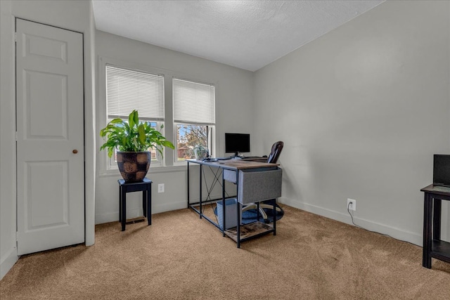 home office featuring carpet flooring, a textured ceiling, and baseboards