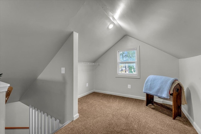 bonus room featuring lofted ceiling, carpet flooring, and baseboards