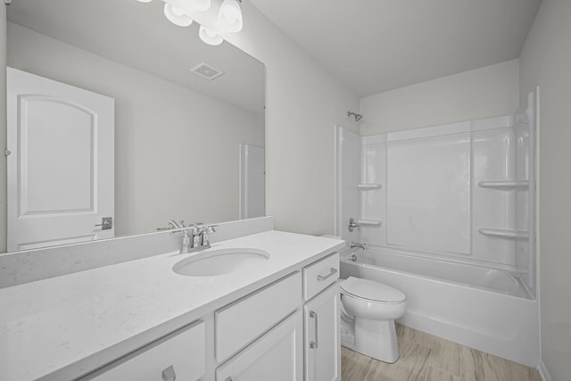 full bathroom with visible vents, vanity, toilet, and tub / shower combination