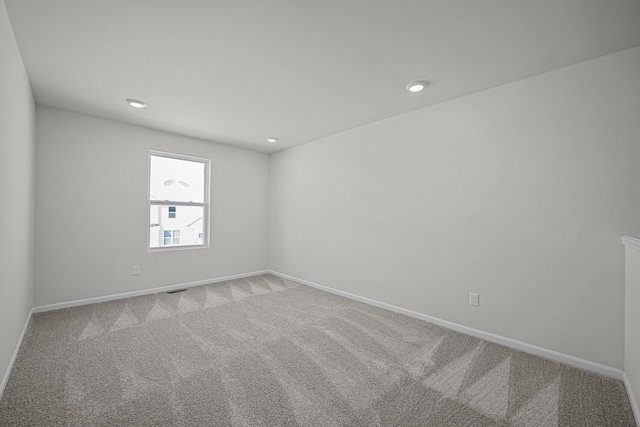 carpeted empty room with recessed lighting, visible vents, and baseboards