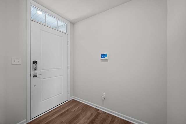 entryway with dark wood-style floors and baseboards