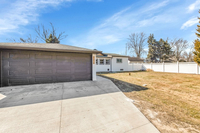 ranch-style house featuring a garage, concrete driveway, fence, and a front lawn