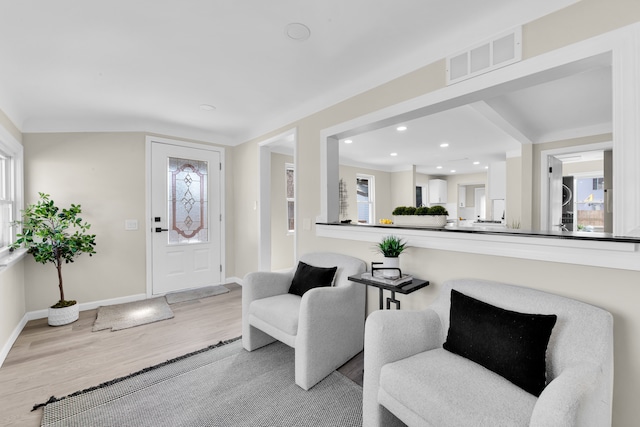 foyer featuring recessed lighting, wood finished floors, visible vents, and baseboards