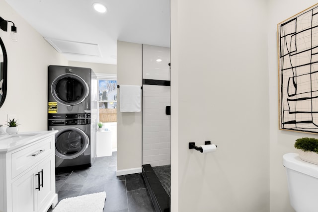 laundry area featuring stacked washing maching and dryer, laundry area, and recessed lighting