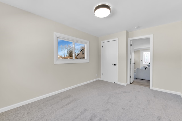 unfurnished bedroom featuring carpet and baseboards