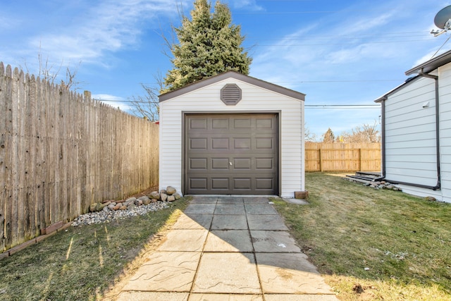 view of outbuilding with an outbuilding, driveway, and fence