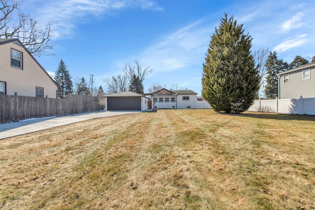 exterior space with an outbuilding, a front yard, fence, and a garage