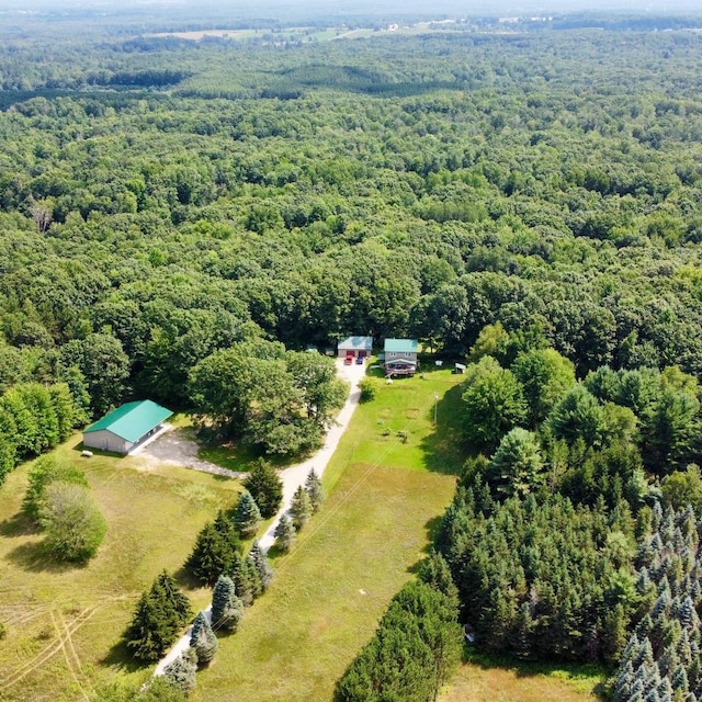 bird's eye view with a wooded view