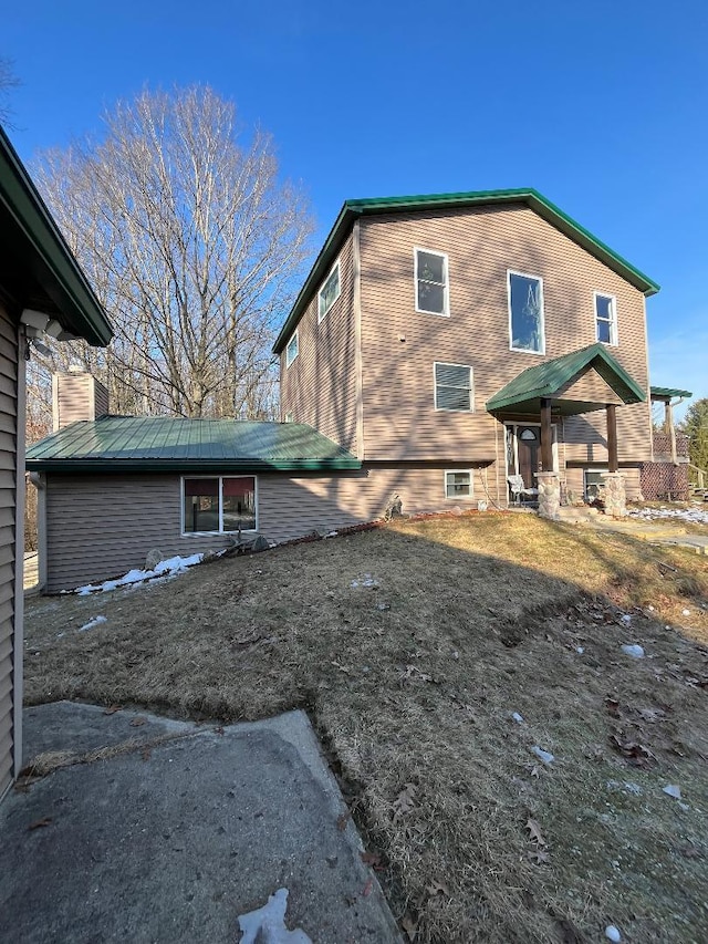 view of side of home with metal roof