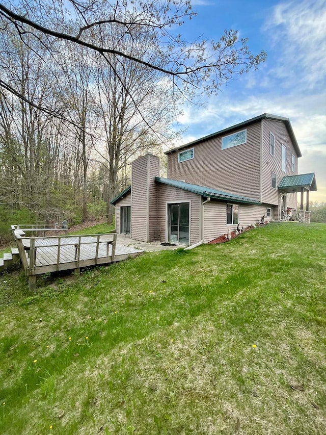 8555 11th Mile, Evart, MI 49631 - rear view of property with a yard and a chimney