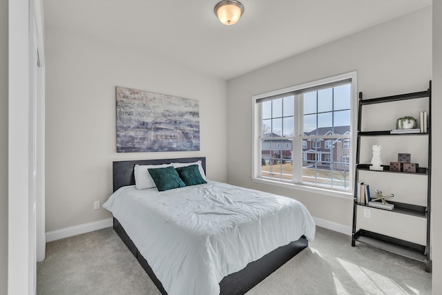 carpeted bedroom featuring baseboards